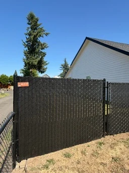 Black chain link fence with privacy slats