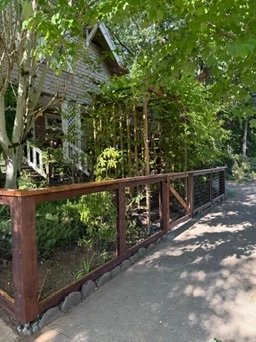 Cedar-framed hog wire fence in a garden